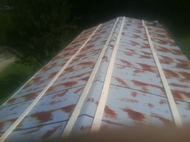 Rusted metal roof panels with new wood purlins before replacement — Storm Damage Roof Repair in Woodford by Roofing Brothers