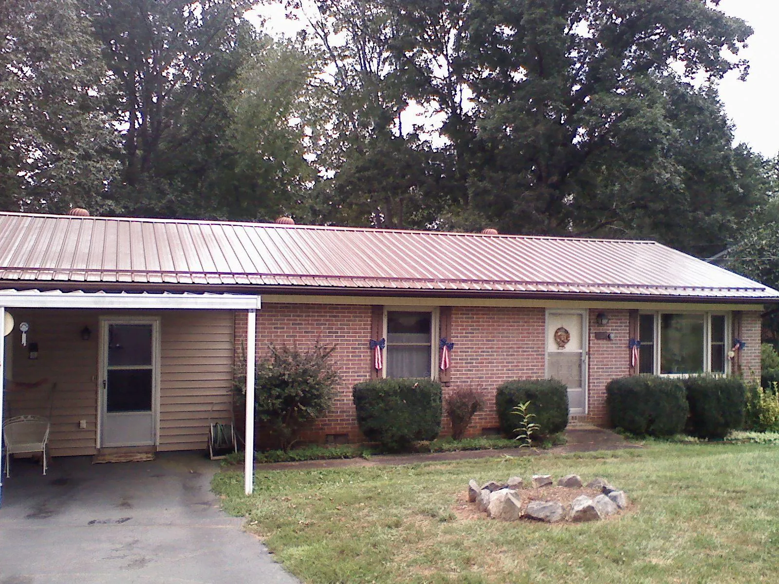 Bronze metal roof and carport on a brick ranch home — Roof Repair work by our crew in Woodford