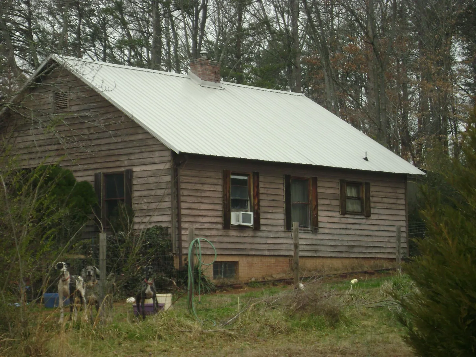 White metal roof on an old wood sided farmhouse, from a Metal Roof Installation job in Woodford
